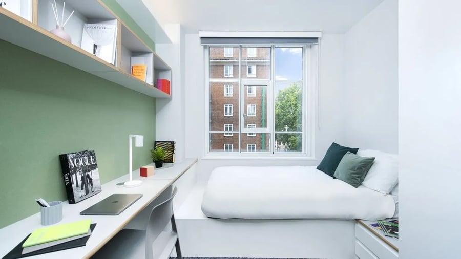 Bed and desk with laptop and books bedroom at Scape Bloomsbury in London Student Accommodation