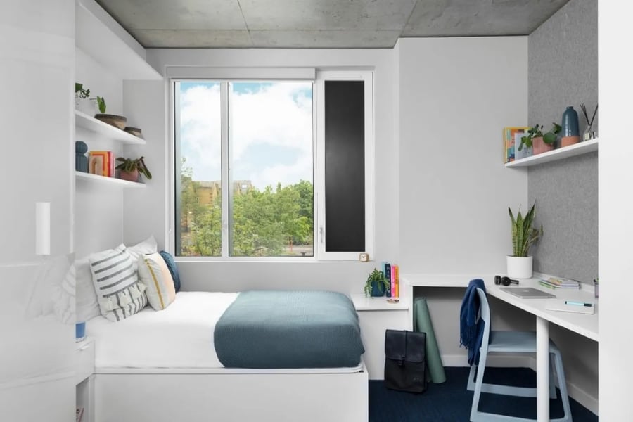 Bed desk window and plants Bedroom at Scape Canada Water in London Student Accommodation