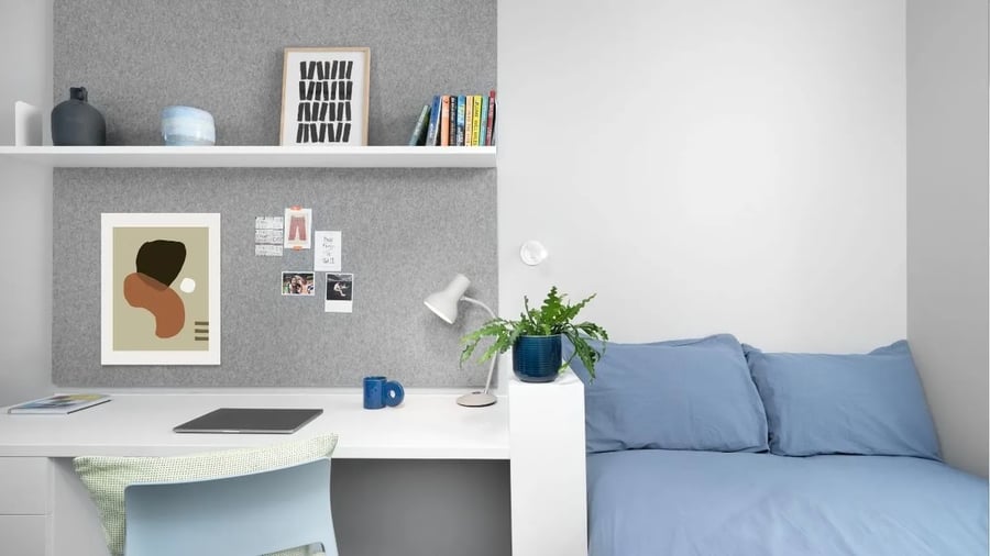 Desk with laptop and bed student room at Scape Canada Water in London Student Accommodation