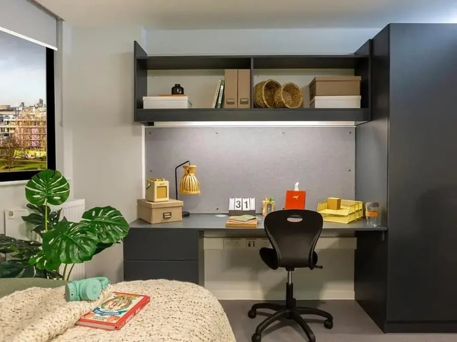 Desk with lamp chair calendar and shelves Bedroom at Element Bermondsey in London Student Accommodation