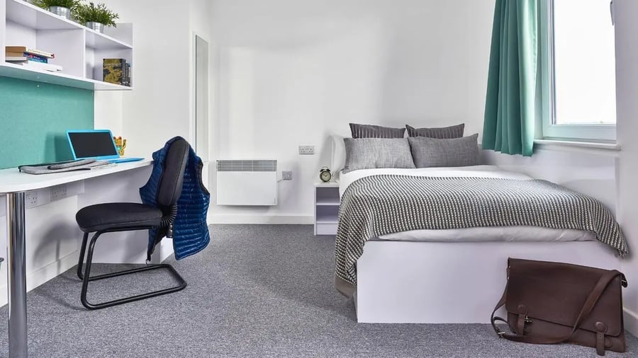 Bed desk chair shelves and bag bedroom at The Glassworks Leicester in Leicester Student Accommodation
