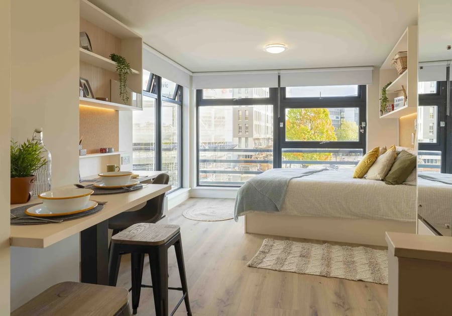 Bed desk dining table and stools bedroom at iQ Bristol in Bristol Student Accommodation