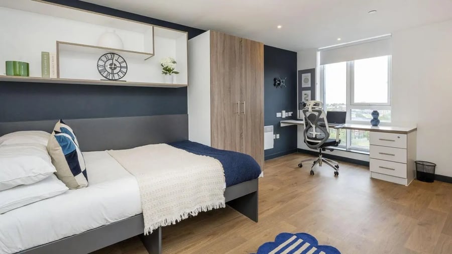 Bed wardrobe desk chair and window bedroom at Innovo House in Liverpool Student Accommodation