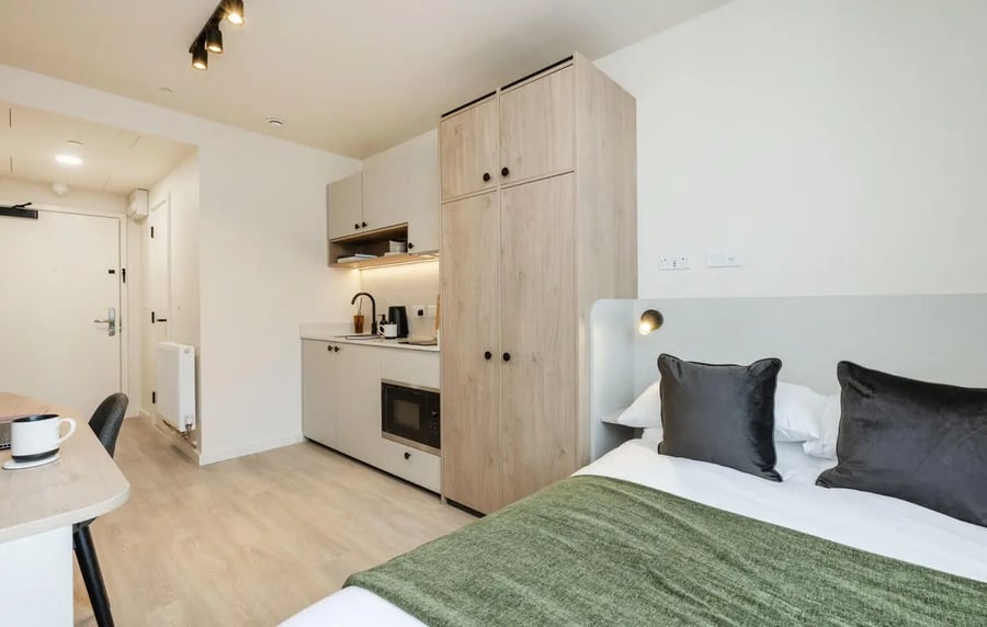 Bed kitchen and wardrobe studio room at Press House in London Student Accommodation