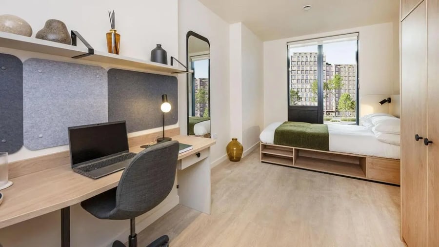 Desk laptop chair bed with green throw Bedroom at Press House in London Student Accommodation