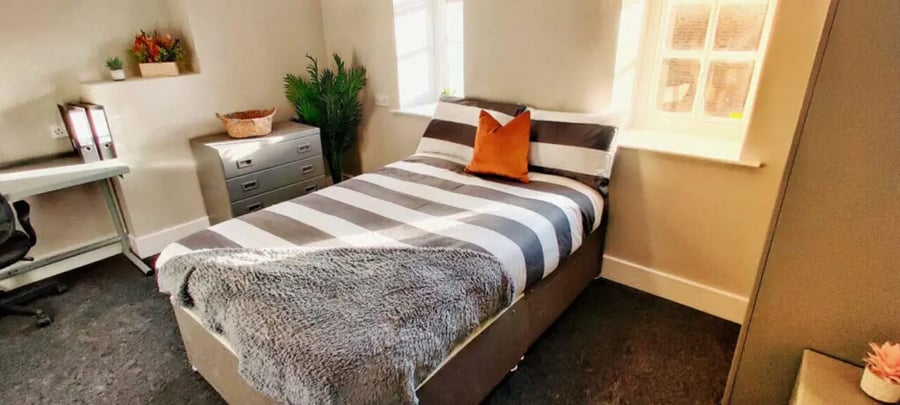 Bed desk drawers plant window bedroom at St Mary's Newcastle in Newcastle Upon Tyne Student Accommodation