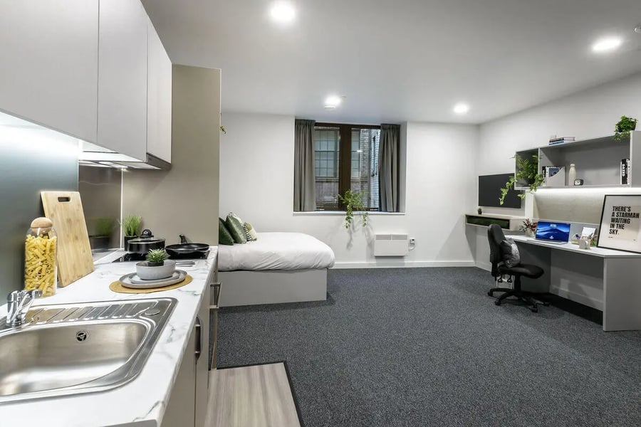 Kitchen sink bed desk and shelves studio apartment at True Leicester in Leicester Student Accommodation
