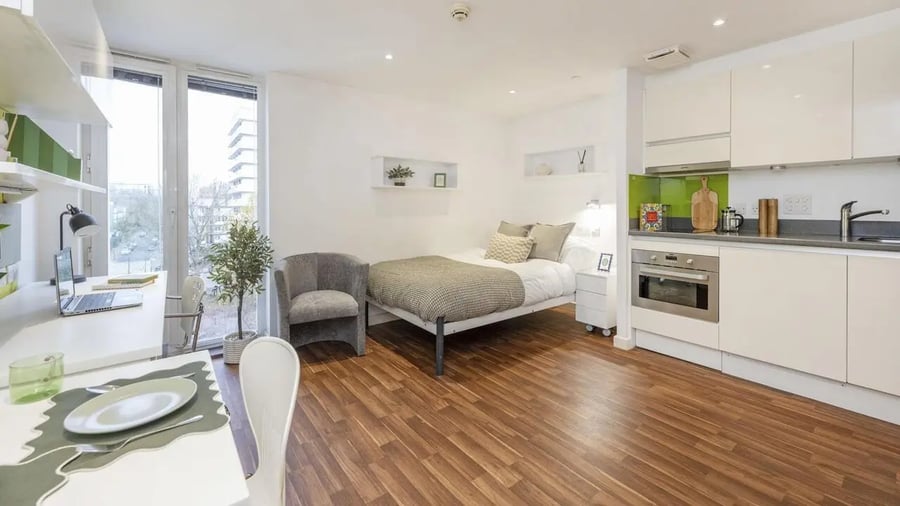 Bed laptop desk chair bedside cabinet kitchen studio apartment at Griffon Studios in London Student Accommodation