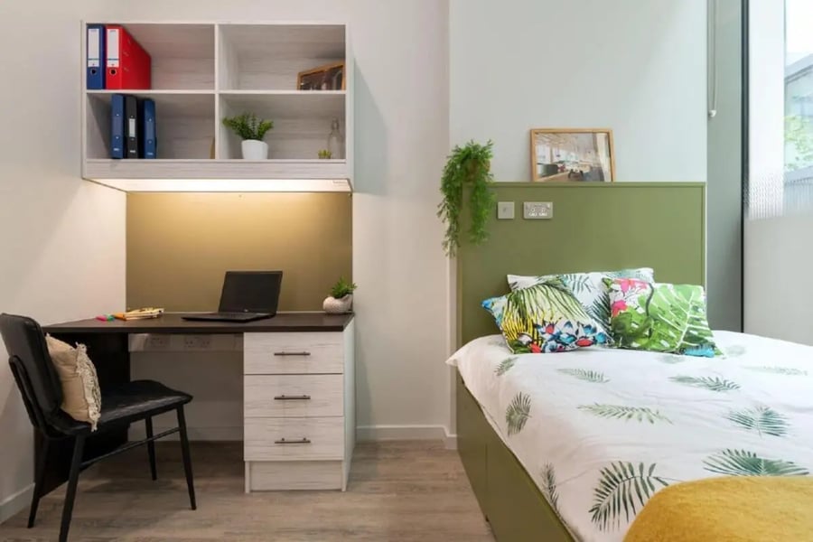 Desk shelf laptop and bed bedroom at Flora Building - Hoxton in London Student Accommodation