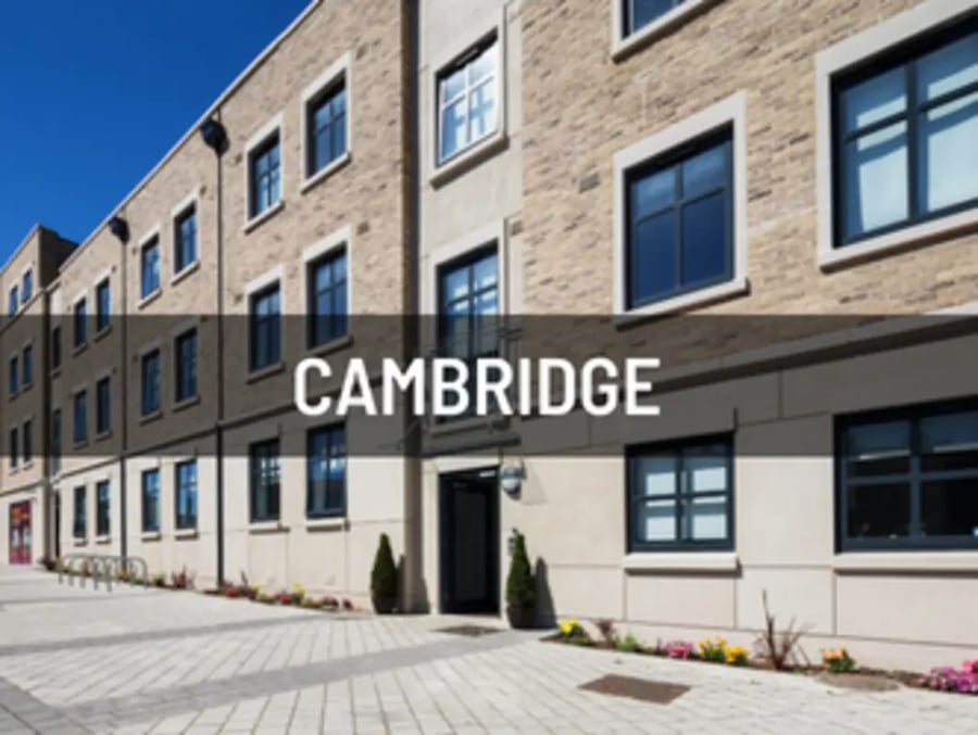 Brick building with windows and paved walkway exterior at Castle Hill in Cambridge Student Accommodation