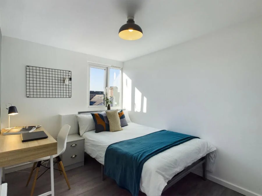 Bed desk lamp grid wall white bedroom at 4 Bedroom House at 75, Saxony Road in Liverpool Student Accommodation