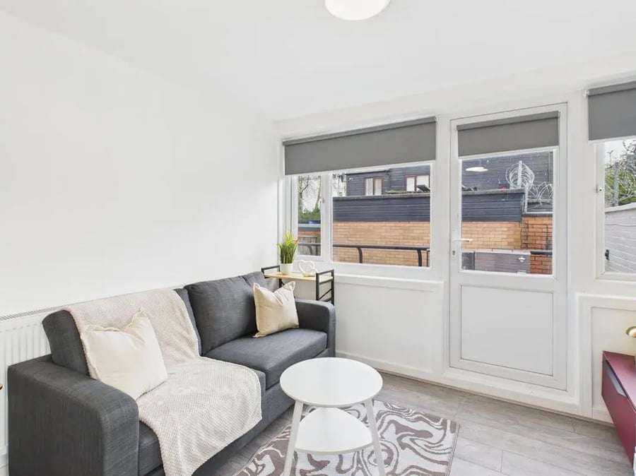 Grey sofa white tables and patterned rug Living room at 2 Bedroom House at Flat 1, Grove Street Studios, The Groves in Liverpool Student Accommodation