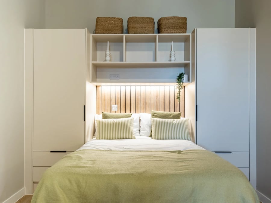 Bed with striped pillows and built-in wardrobe bedroom at Fitz and Knox in Cardiff Student Accommodation