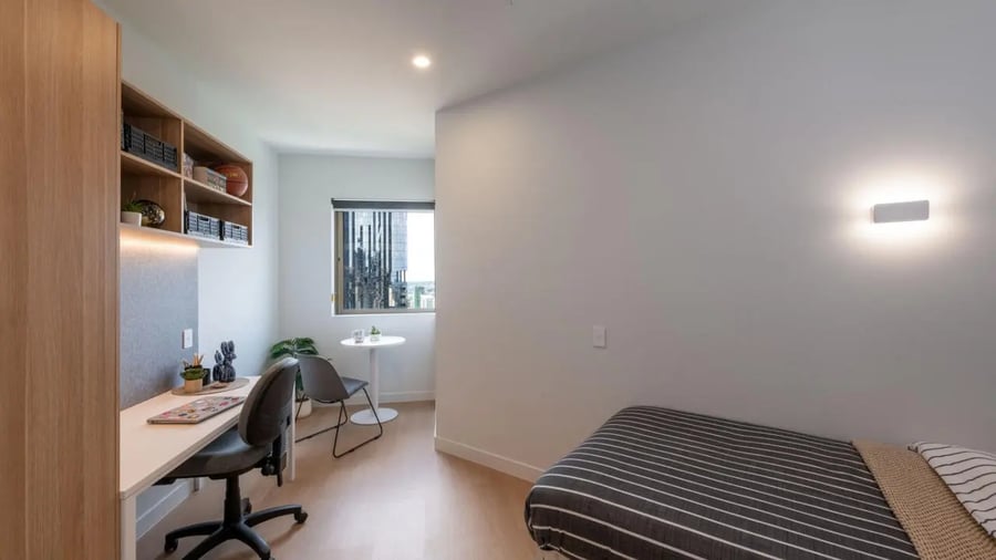 Desk chair bed shelves window living room at UniLodge Brisbane City in Charleston Student Accommodation