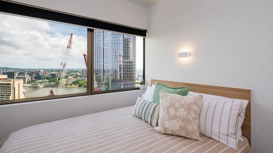 Bed with pillows city view Bedroom at UniLodge Brisbane City in Charleston Student Accommodation
