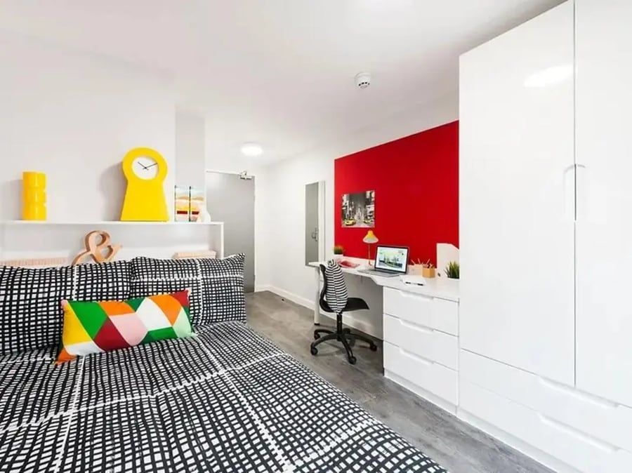Bed with desk wardrobe and red wall bedroom at Yugo Arofan House in Cardiff Student Accommodation