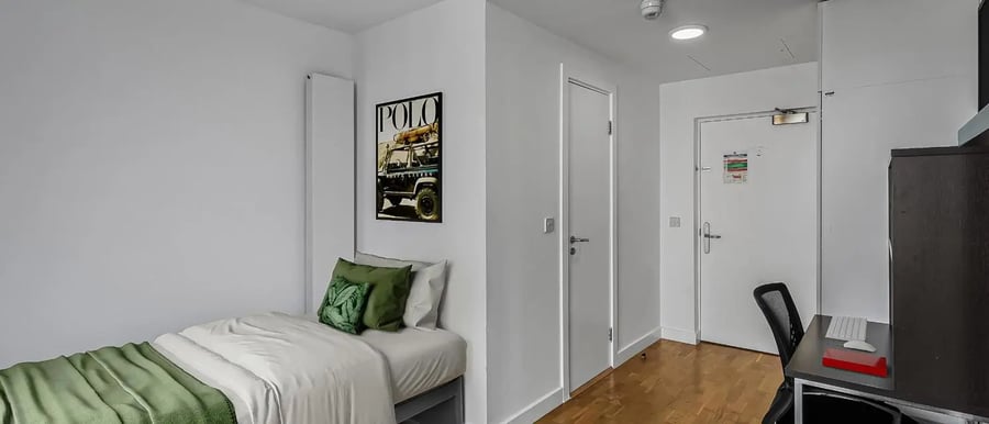 Bed desk chair poster and door Bedroom at Chapter Kings Cross in London Student Accommodation