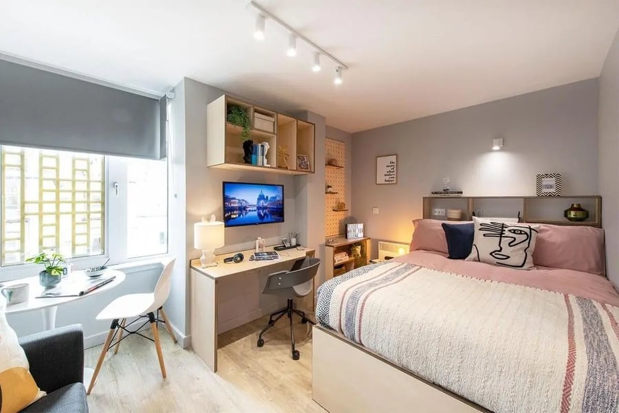 Bed desk shelves TV window and chair bedroom at Silk Mill Edinburgh in Edinburgh Student Accommodation