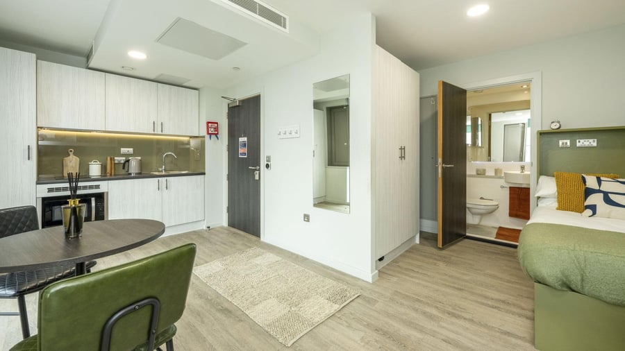 Kitchen table bed bathroom visible Studio apartment at Flora Building - Hoxton in London Student Accommodation