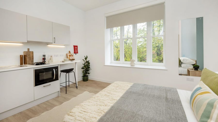 Kitchenette bed large window and mirror bedroom at St Gabriels in Manchester Student Accommodation