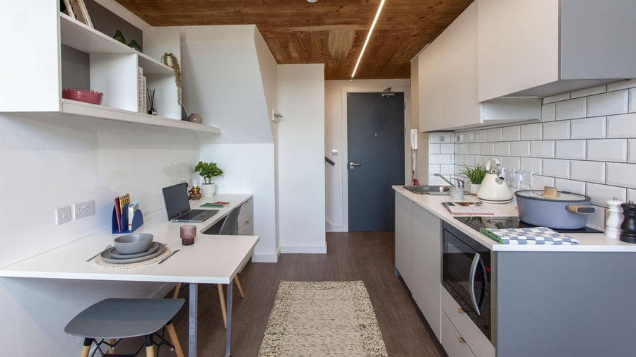 Desk laptop shelving and kitchen area kitchen at Gillows in Lancaster Student Accommodation