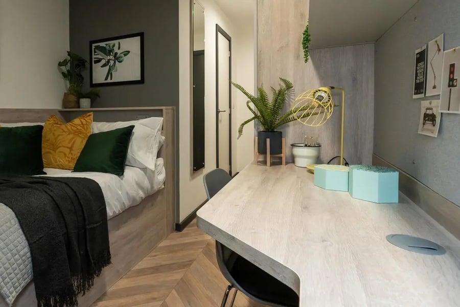 Bed desk with plants and lamp bedroom study at Steelworks in Sheffield Student Accommodation