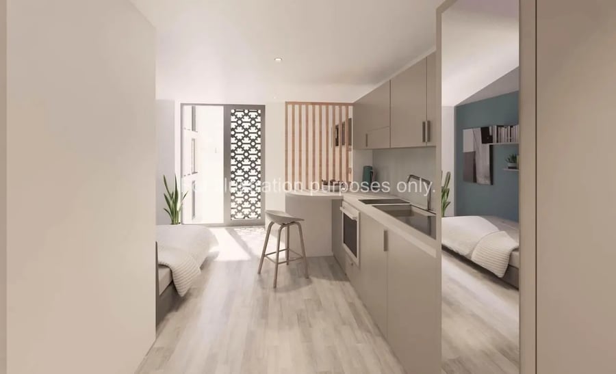 Bed kitchen and stool student apartment interior at St Gabriels in Manchester Student Accommodation