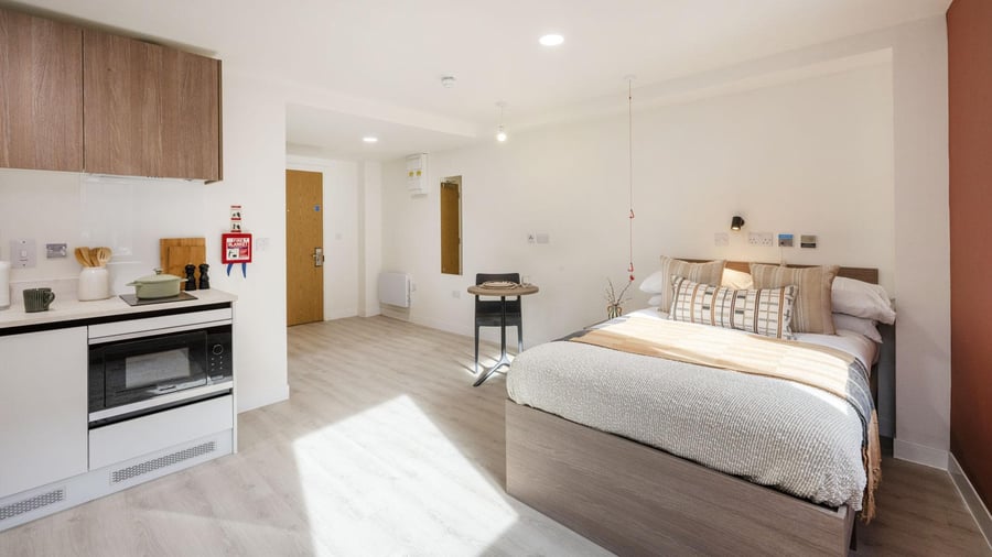 Bed kitchen table and door student studio at Raffles Hall in York Student Accommodation