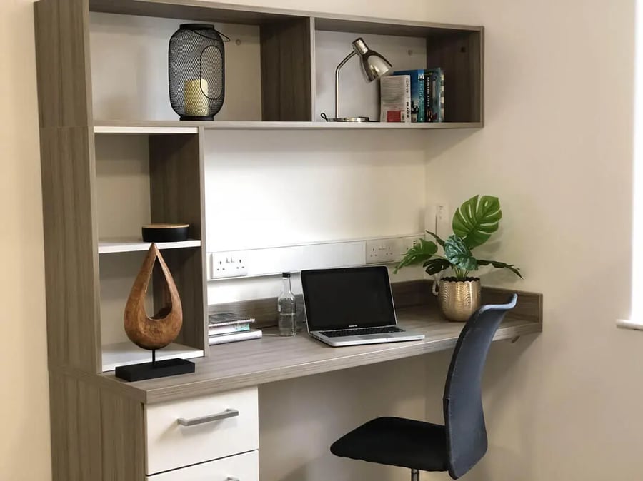 Desk with laptop plant and chair study area at Q Studios in Stoke-On-Trent Student Accommodation