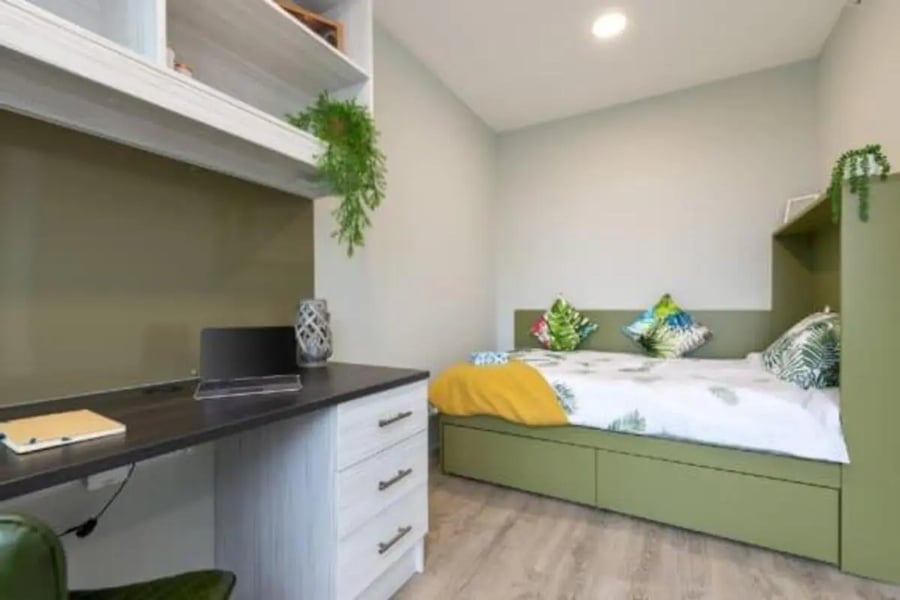Desk laptop bed with tropical pillows Bedroom at Flora Building - Hoxton in London Student Accommodation