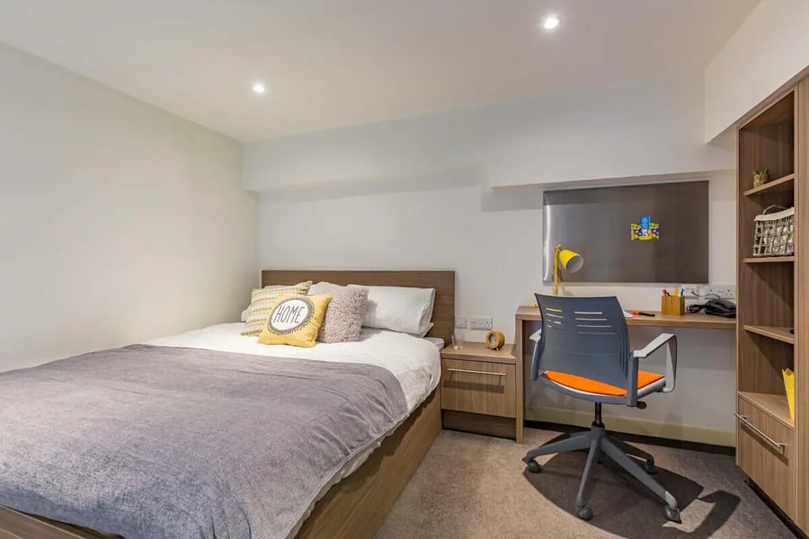 Bed desk chair and shelving unit bedroom at Gallery Apartments in Glasgow Student Accommodation
