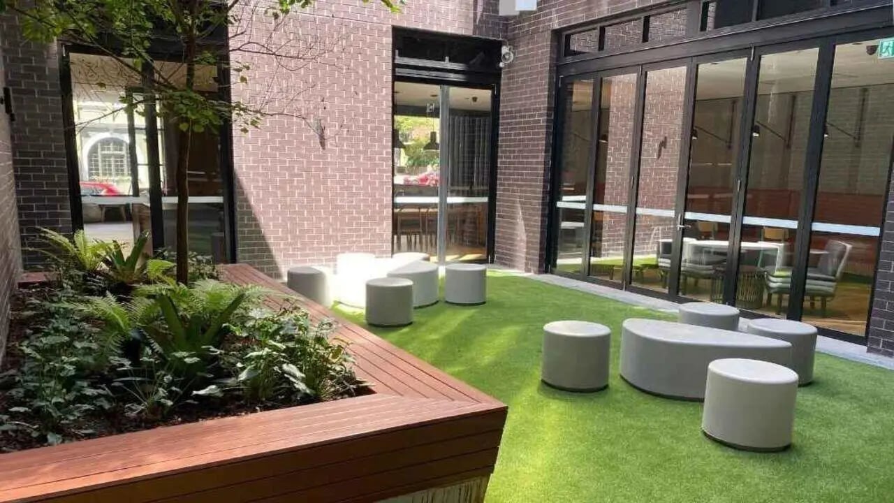 Green lawn with modern seating courtyard area at UniLodge Ultimo in Sydney Student Accommodation