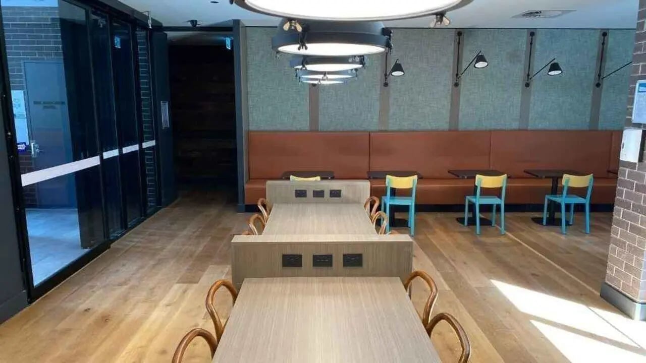 Two tables with chairs and outlets common area at UniLodge Ultimo in Sydney Student Accommodation