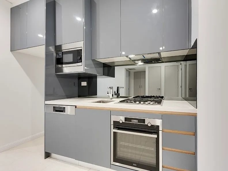 Gray cabinets microwave oven stove dishwasher kitchen at Belong Mascot in Sydney Student Accommodation