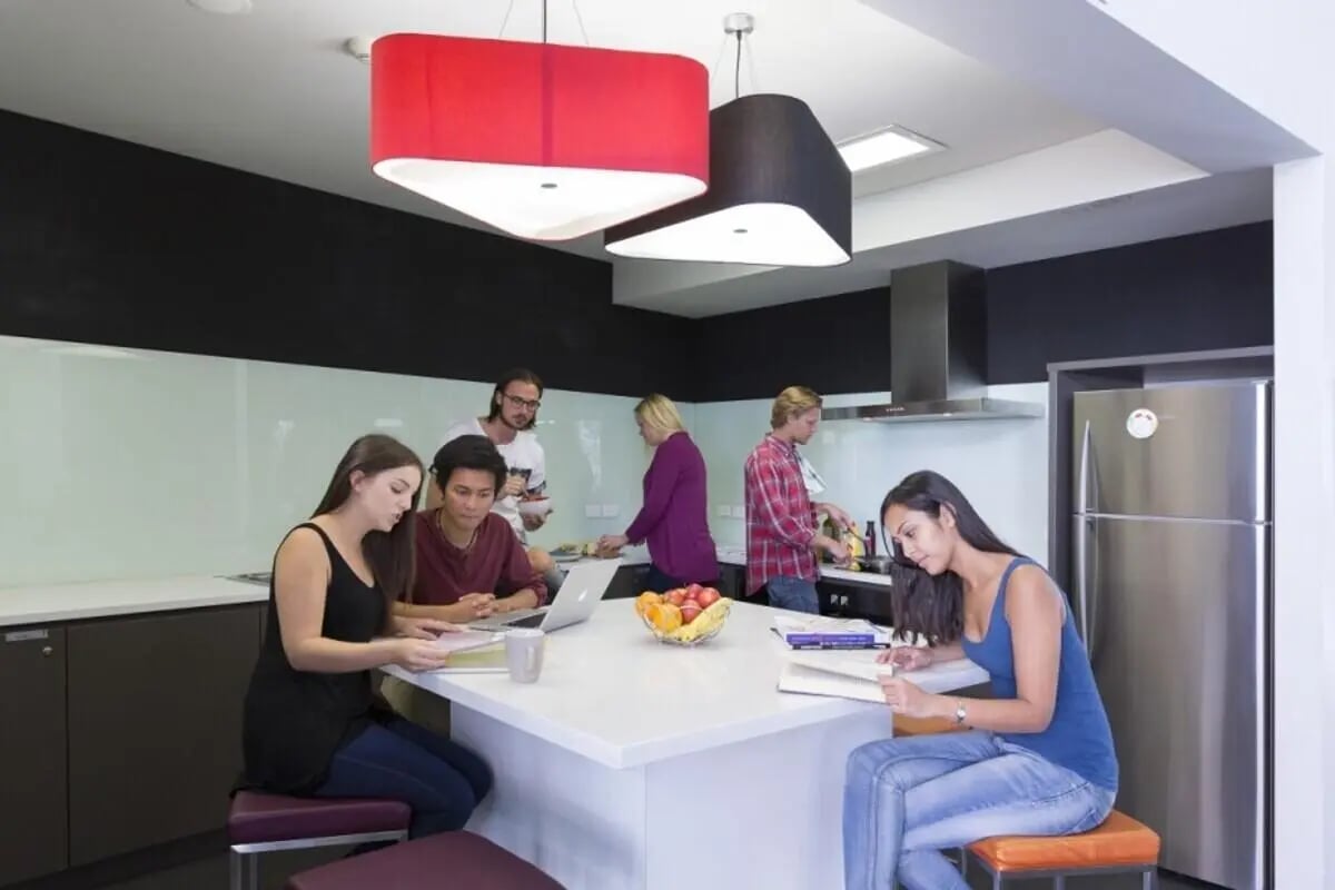 Students studying and cooking in modern kitchen area at ECU Villlage Mount Lawley in Perth Student Accommodation