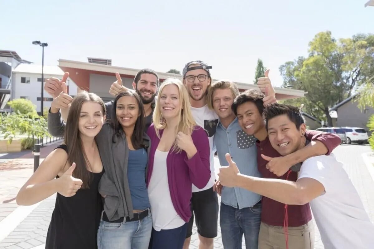 Students posing with thumbs up exterior at ECU Villlage Mount Lawley in Perth Student Accommodation