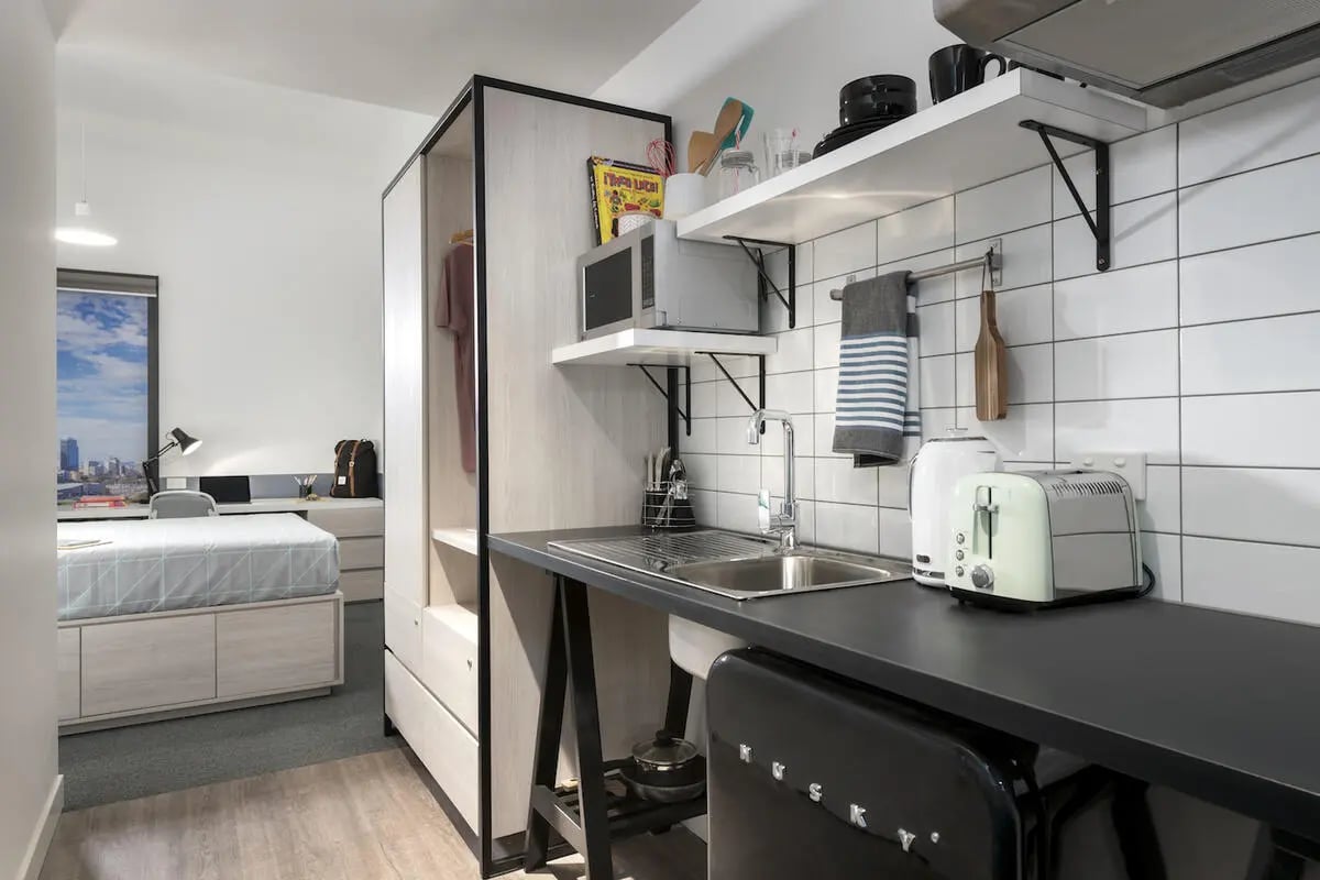 Bed desk microwave sink toaster kitchen area at Campus Perth in Perth Student Accommodation
