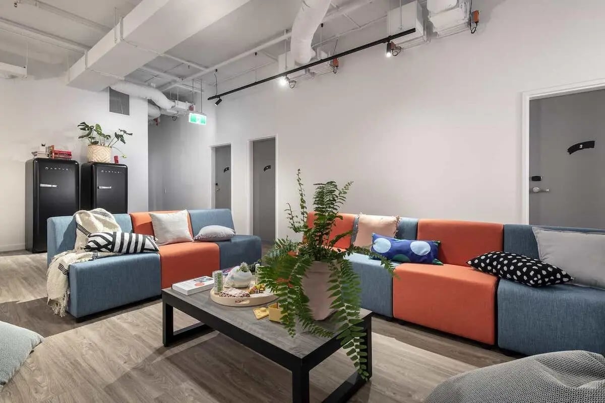Modular sofas coffee table with plant living area at Campus Perth in Perth Student Accommodation