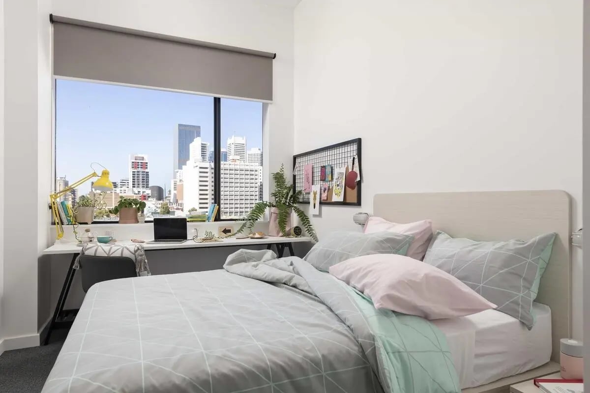 Bed with desk and city view bedroom at Campus Perth in Perth Student Accommodation