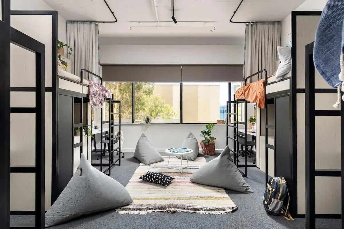 Bunk beds desks beanbags and rug communal area bedroom at Campus Perth in Perth Student Accommodation