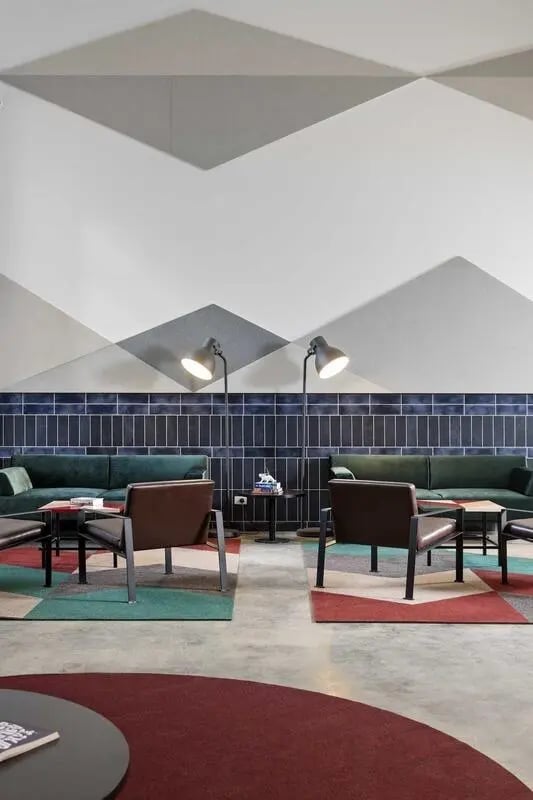 Sofa chairs tables floor lamps geometric carpet living area at Campus Perth in Perth Student Accommodation