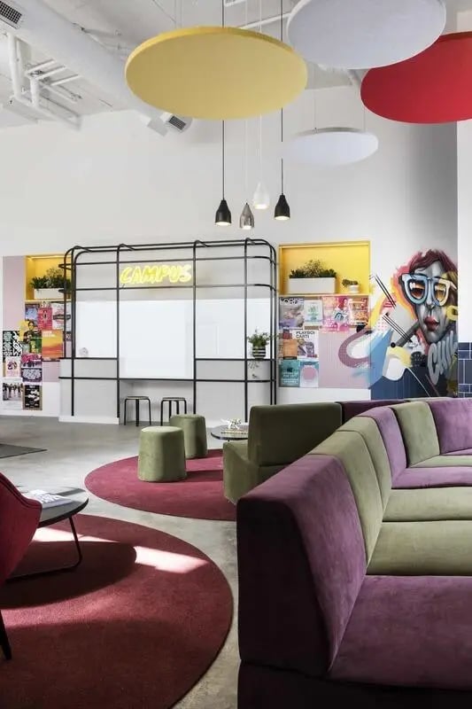 Modular purple and green sofa with circular rugs and artwork living room at Campus Perth in Perth Student Accommodation