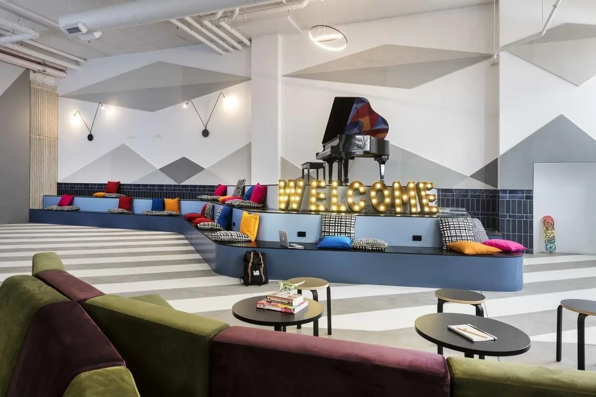Piano welcome sign tiered seating living room at Campus Perth in Perth Student Accommodation