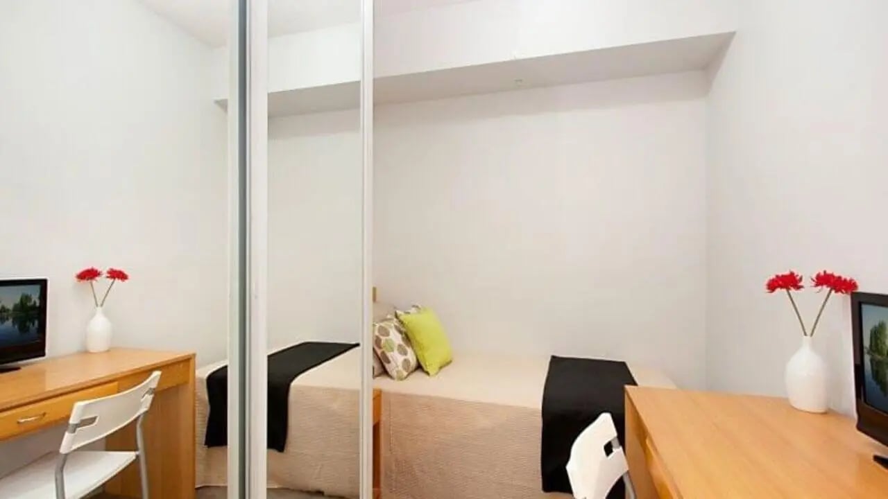 Bed desk TV red flowers study bedroom at Student Living - 570 Swanston in Melbourne Student Accommodation