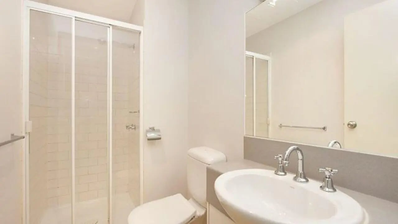 Shower toilet sink with faucets bathroom at Student Living - 570 Swanston in Melbourne Student Accommodation