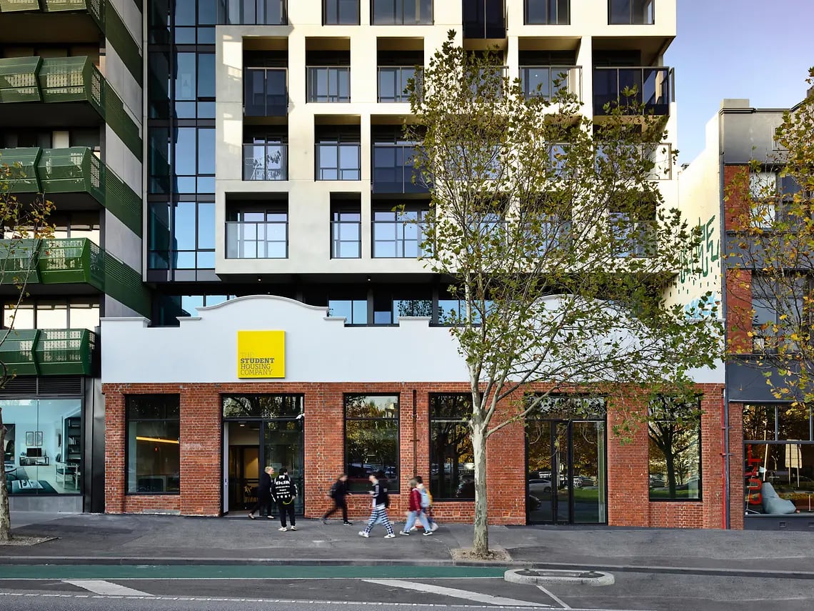 Modern building facade with people walking exterior at Yugo Berkeley Street in Melbourne Student Accommodation