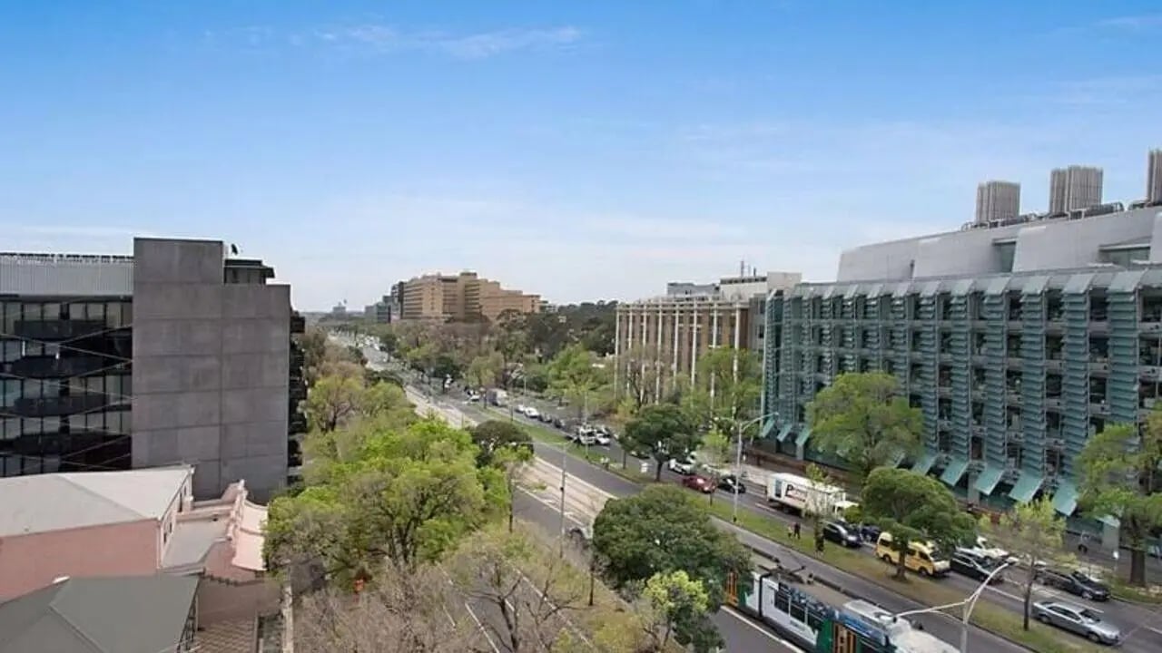 City street with tram cars and buildings exterior at Student Living on Villiers in Melbourne Student Accommodation