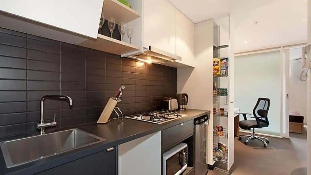 Modern kitchen with sink stove and storage kitchen at Student Living on Villiers in Melbourne Student Accommodation
