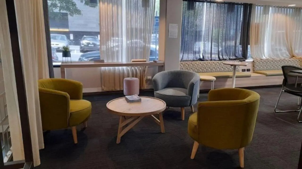 Armchairs coffee table and bench seating lounge area at Student Living on Villiers in Melbourne Student Accommodation