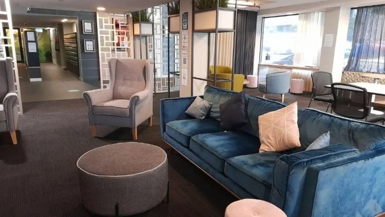 Blue sofa armchair ottoman common area at Student Living on Villiers in Melbourne Student Accommodation